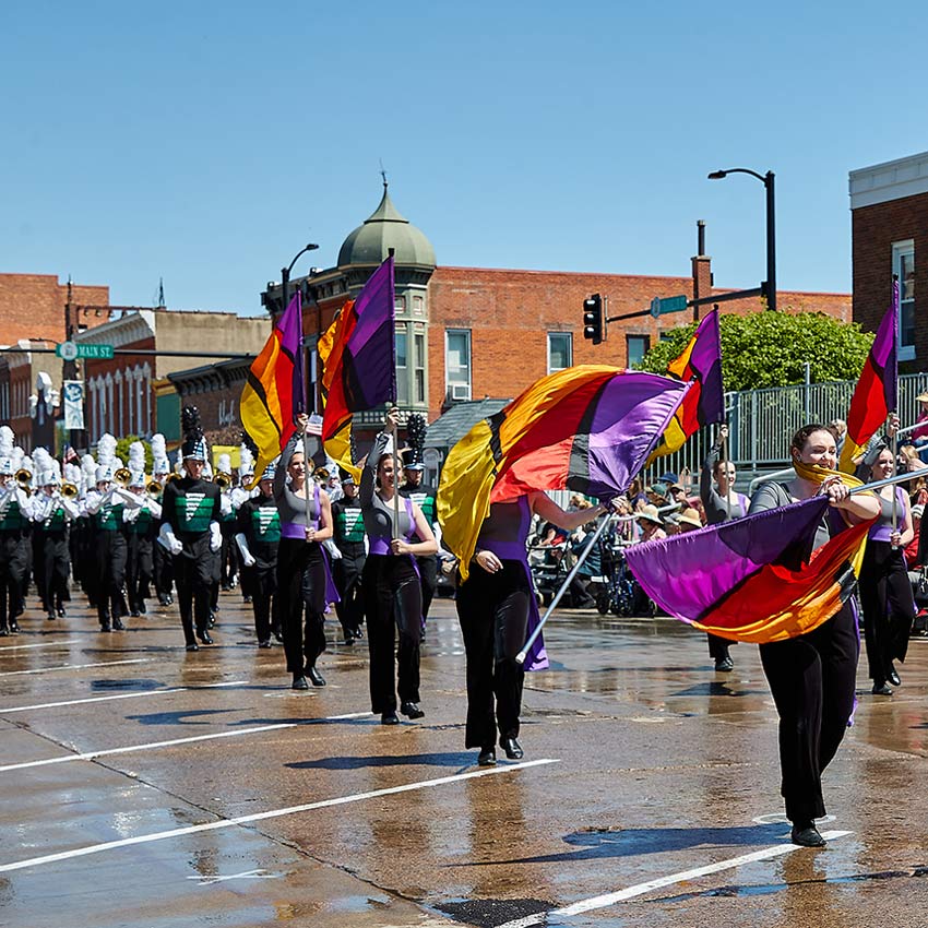 people twirling flags in a parade